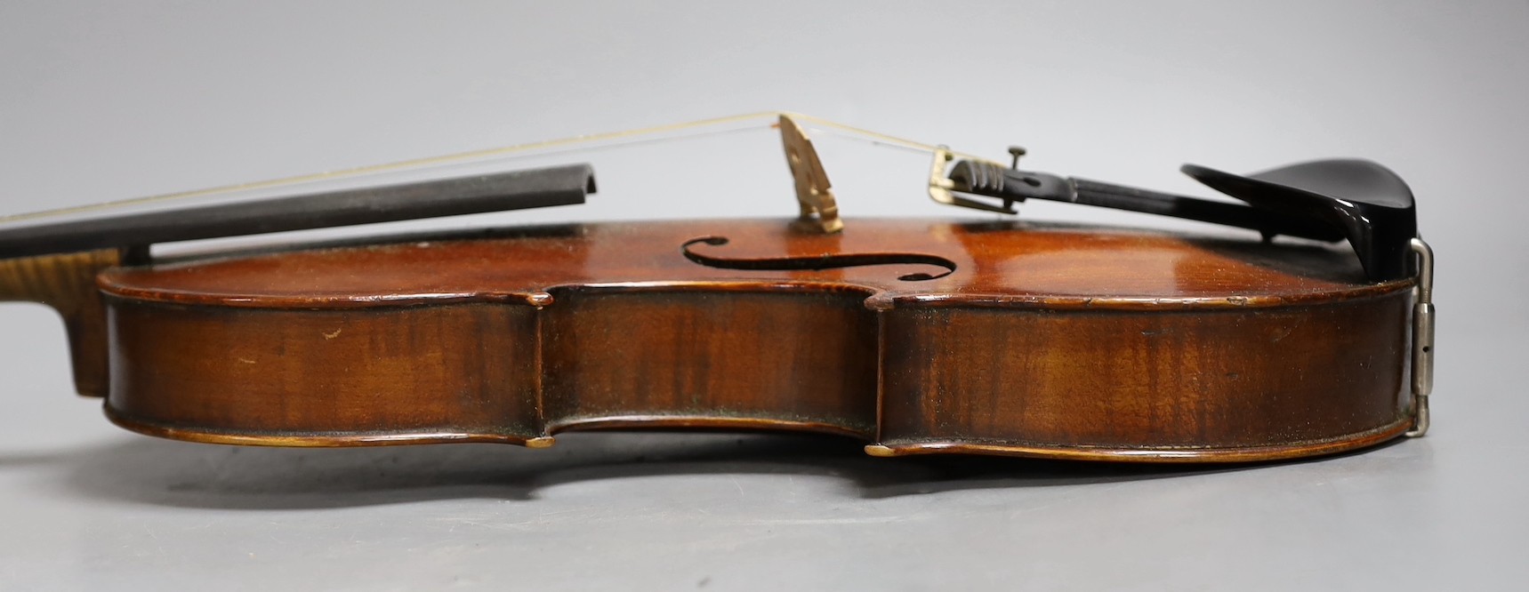 A cased late 19th century English violin, inscribed W. Heaton maker 1887 (?), back measures 35.5cm excl button